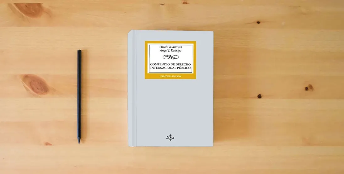 The book Compendio de Derecho Internacional Público (Derecho - Biblioteca Universitaria de Editorial Tecnos)} is on the table