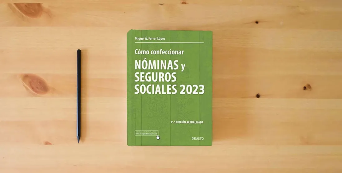 The book Cómo confeccionar nóminas y seguros sociales 2023 (Deusto)} is on the table