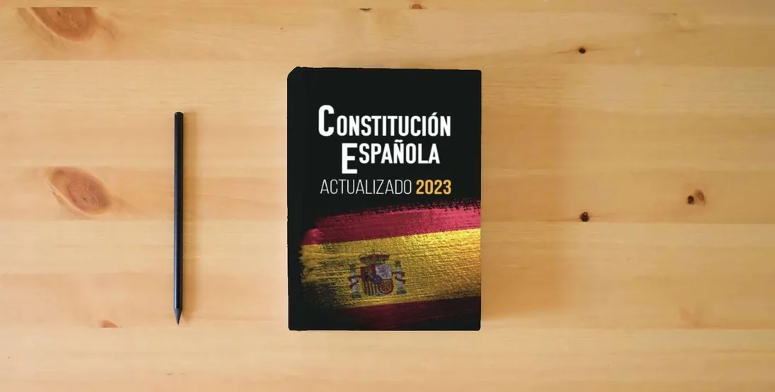 The book CONSTITUCIÓN ESPAÑOLA: Edición actualizada para opositores} is on the table