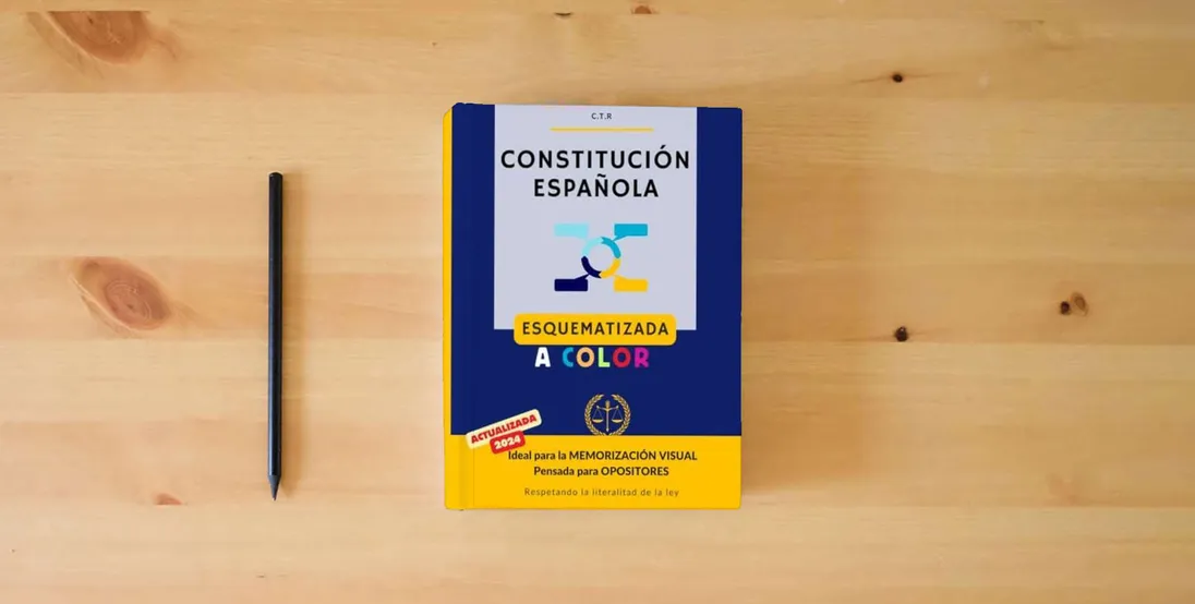 The book Constitución Española (Ilustrado): Esquematizada a color | Para Opositores | Gran formato} is on the table