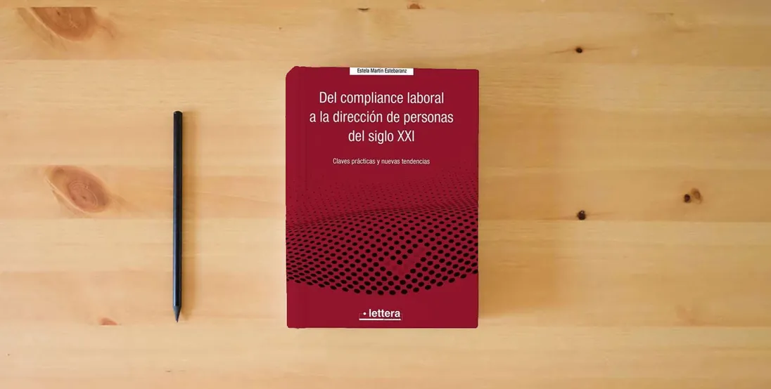 The book Del Compliance laboral a la dirección de personas del siglo XXI: Claves prácticas y nuevas tendencias} is on the table