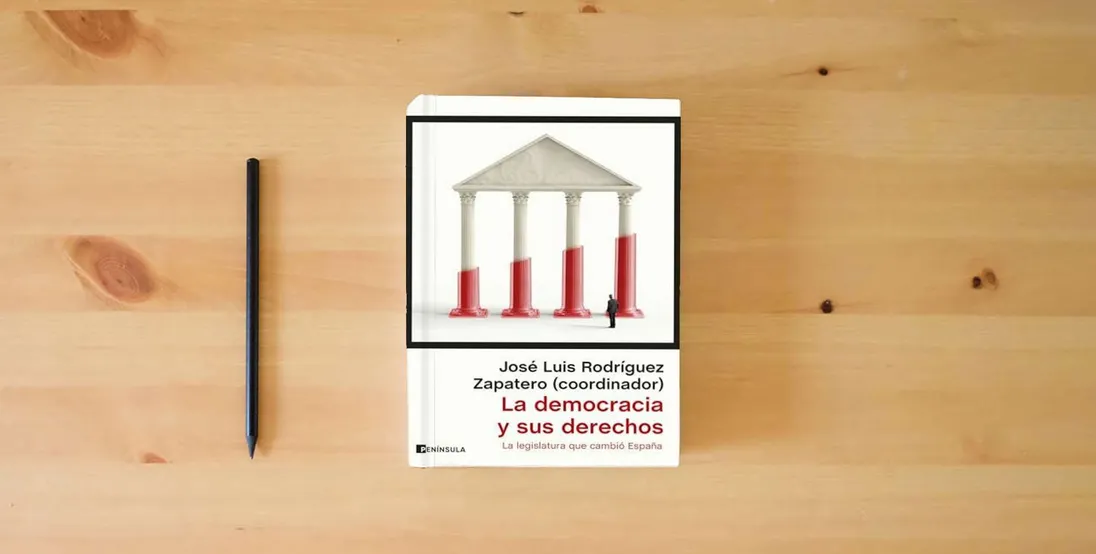 The book La democracia y sus derechos: La legislatura que cambió España (ATALAYA)} is on the table