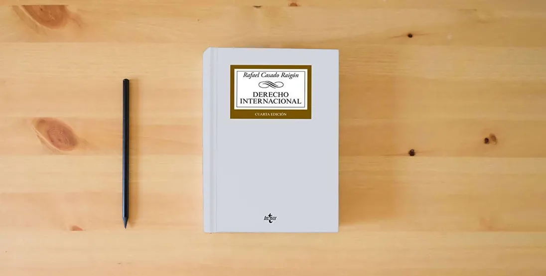 The book Derecho Internacional (Derecho - Biblioteca Universitaria de Editorial Tecnos)} is on the table