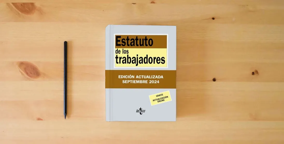 The book Estatuto de los Trabajadores (Derecho - Biblioteca de Textos Legales)} is on the table