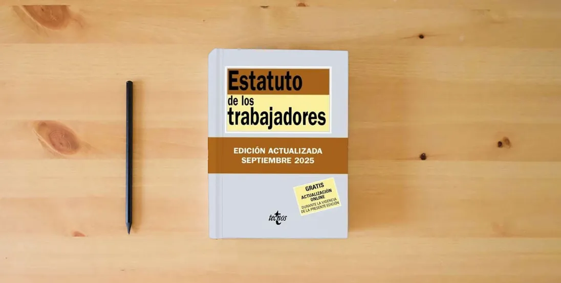 The book Estatuto de los Trabajadores (Derecho - Biblioteca de Textos Legales)} is on the table