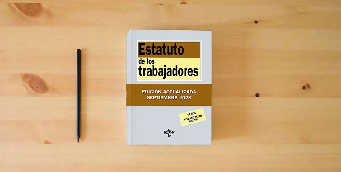 The book Estatuto de los Trabajadores (Derecho - Biblioteca de Textos Legales)} is on the table
