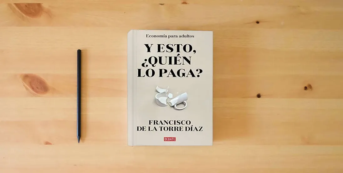 The book ¿Y esto quién lo paga?: Economía para adultos (Sociedad)} is on the table