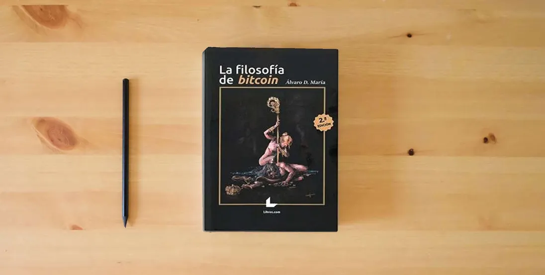 The book LA FILOSOFÍA DE BITCOIN - 2ª EDICIÓN (SIN COLECCION)} is on the table