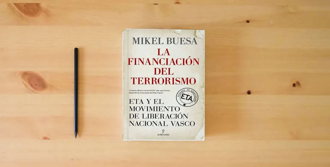 The book La financiación del terrorismo; ETA y el Movimiento de Liberación Nacional Vasco (Pensamiento político)} is on the table
