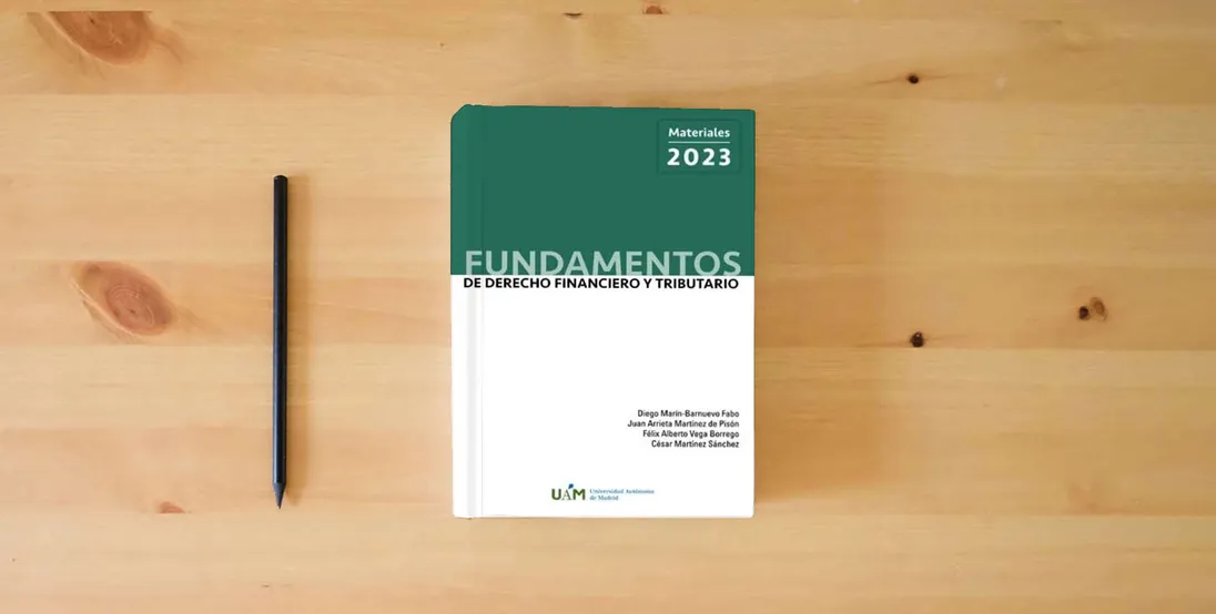 The book Fundamentos de Derecho Financiero y Tributario. Materiales 2023.} is on the table