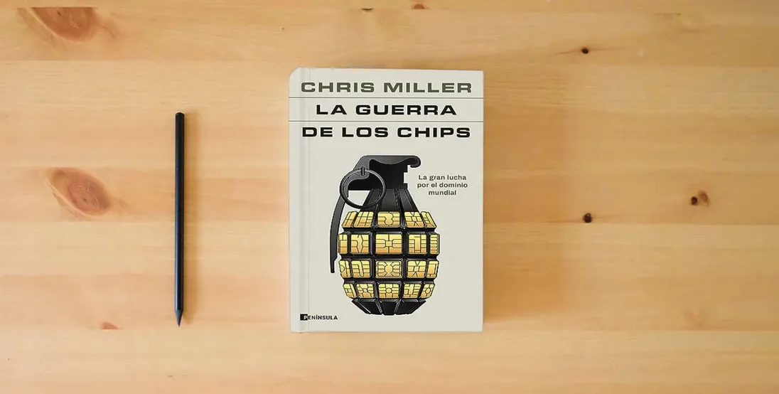 The book La guerra de los chips: La gran lucha por el dominio mundial (PENINSULA)} is on the table