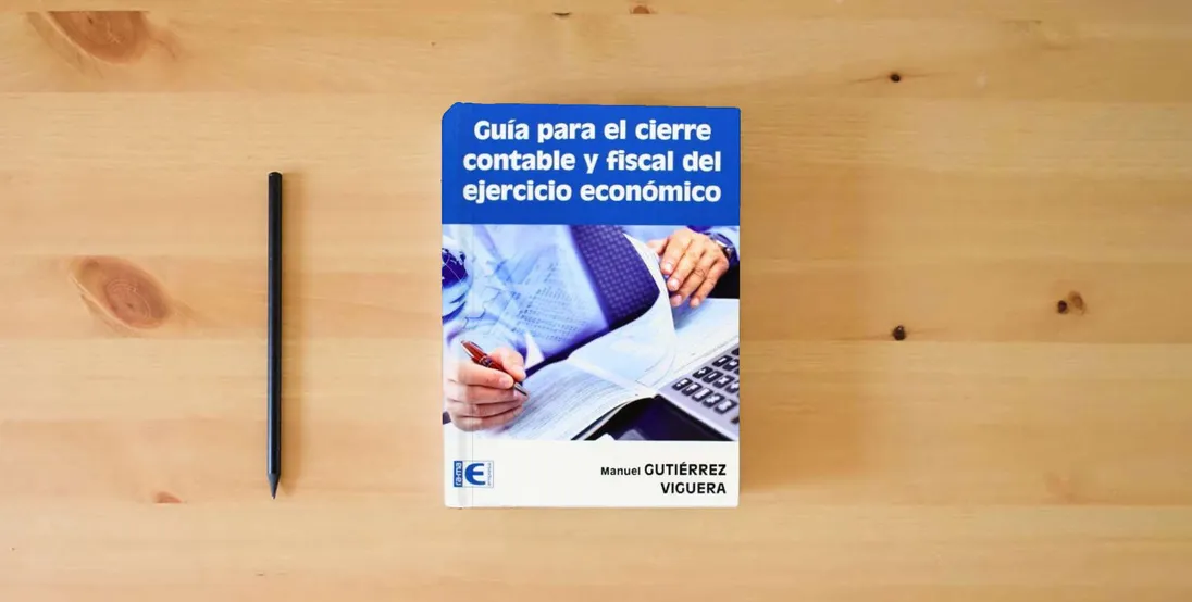 The book Guía para el cierre contable y fiscal del ejercicio económico (EMPRESA)} is on the table