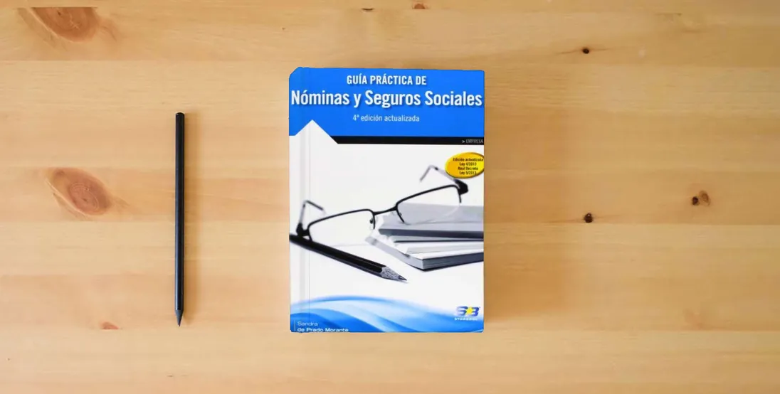 The book Guía Práctica de Nóminas y Seguros Sociales. 4ª Edición (EMPRESA)} is on the table