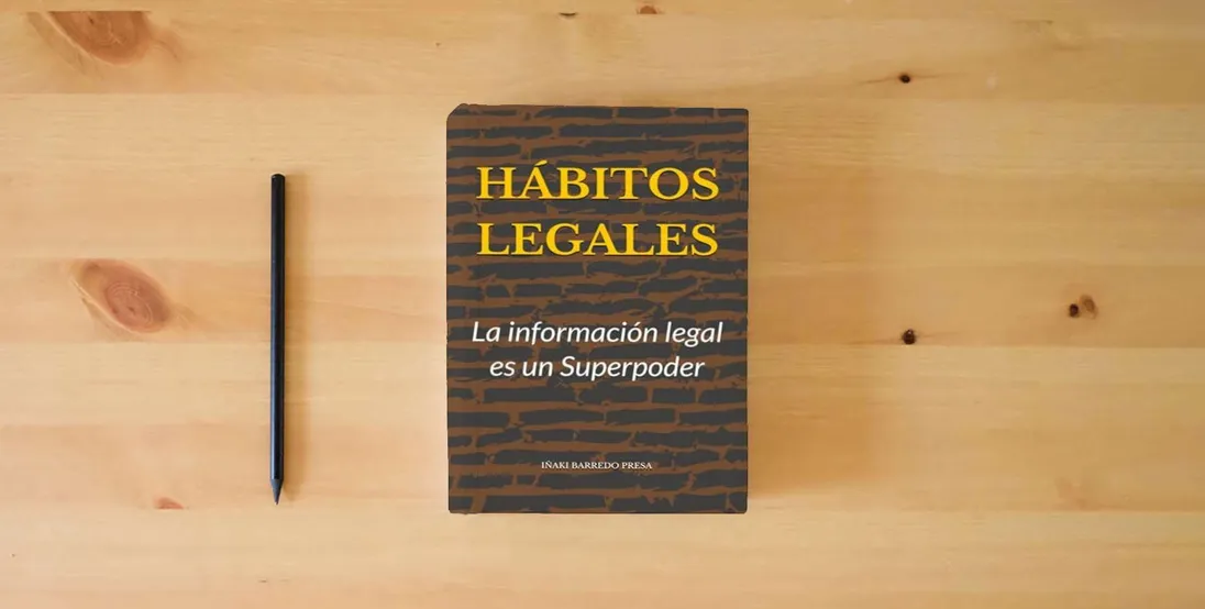 The book HABITOS LEGALES: La información legal es un Superpoder} is on the table