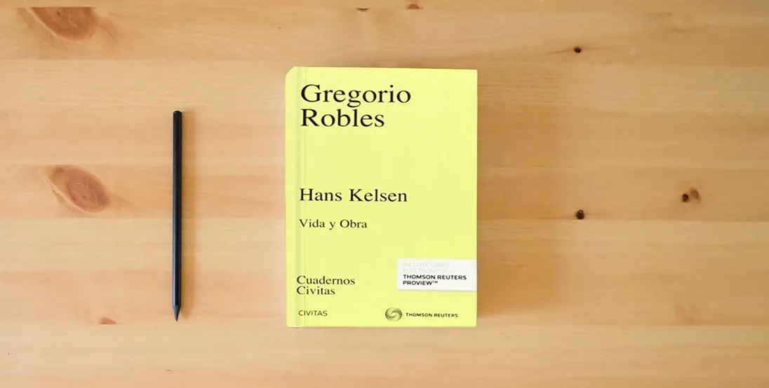 The book Hans Kelsen: Vida y Obra (Cuadernos)} is on the table