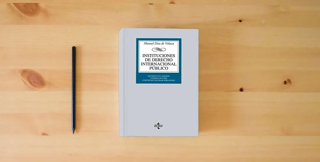 The book Instituciones de Derecho Internacional público (Derecho - Biblioteca Universitaria de Editorial Tecnos)} is on the table