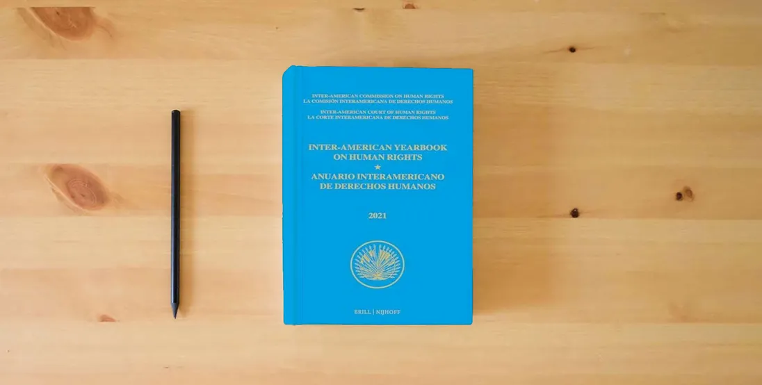 The book Inter-american Yearbook on Human Rights, 2021/ Anuario Interamericano De Derechos Humanos, 2021 (Inter-american Yearbook on Human Rights/ Anuario Interamericano De Derechos Humanos, 37)} is on the table