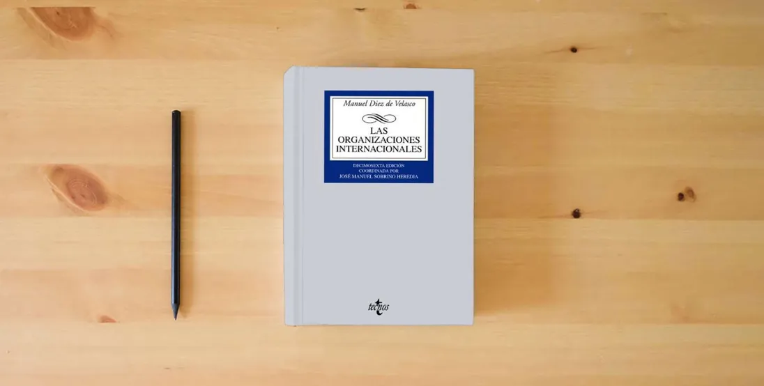The book Las organizaciones internacionales (Derecho - Biblioteca Universitaria de Editorial Tecnos)} is on the table