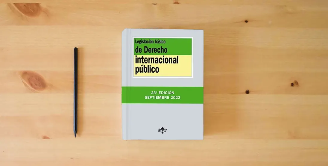 The book Legislación básica de Derecho Internacional público (Derecho - Biblioteca de Textos Legales)} is on the table