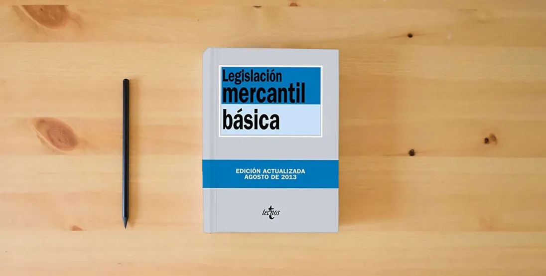 The book Legislación mercantil básica (Derecho - Biblioteca de Textos Legales)} is on the table