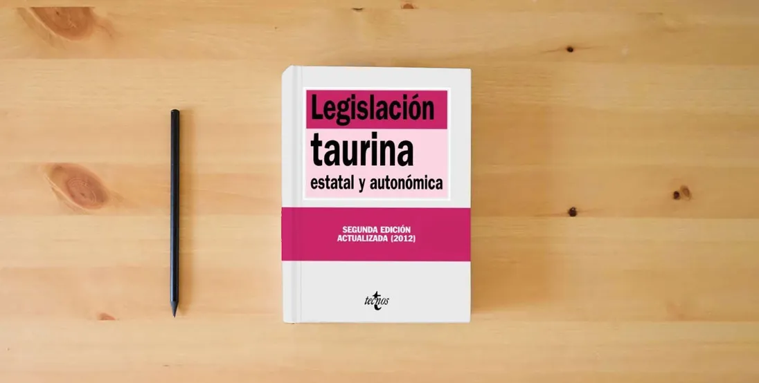 The book Legislación taurina: estatal y autonómica (Derecho - Biblioteca de Textos Legales)} is on the table