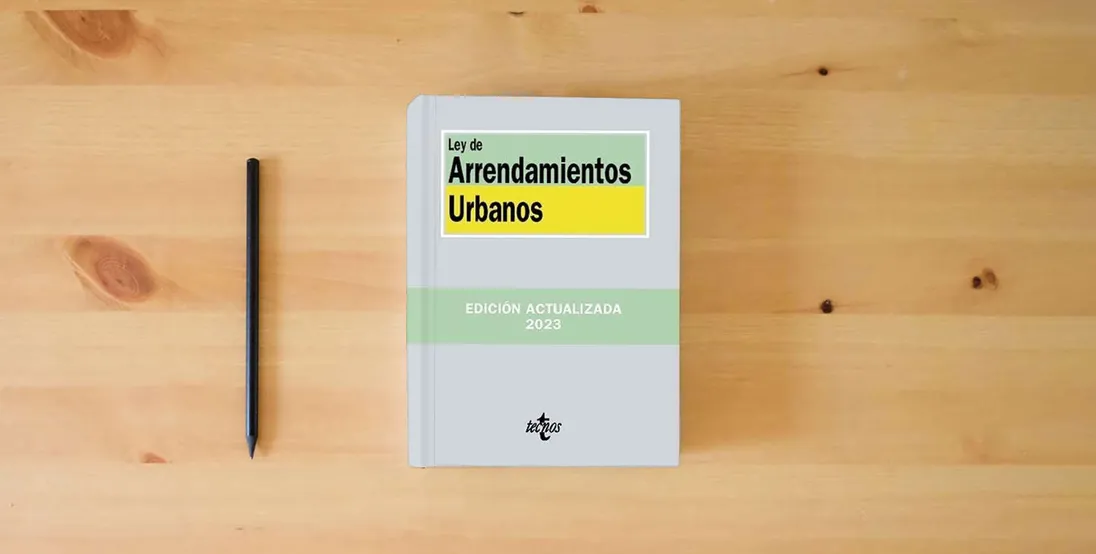 The book Ley de Arrendamientos Urbanos (Derecho - Biblioteca de Textos Legales)} is on the table