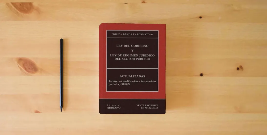The book Ley del Gobierno y Ley de Régimen Jurídico del Sector Público: Edición básica en formato A4} is on the table