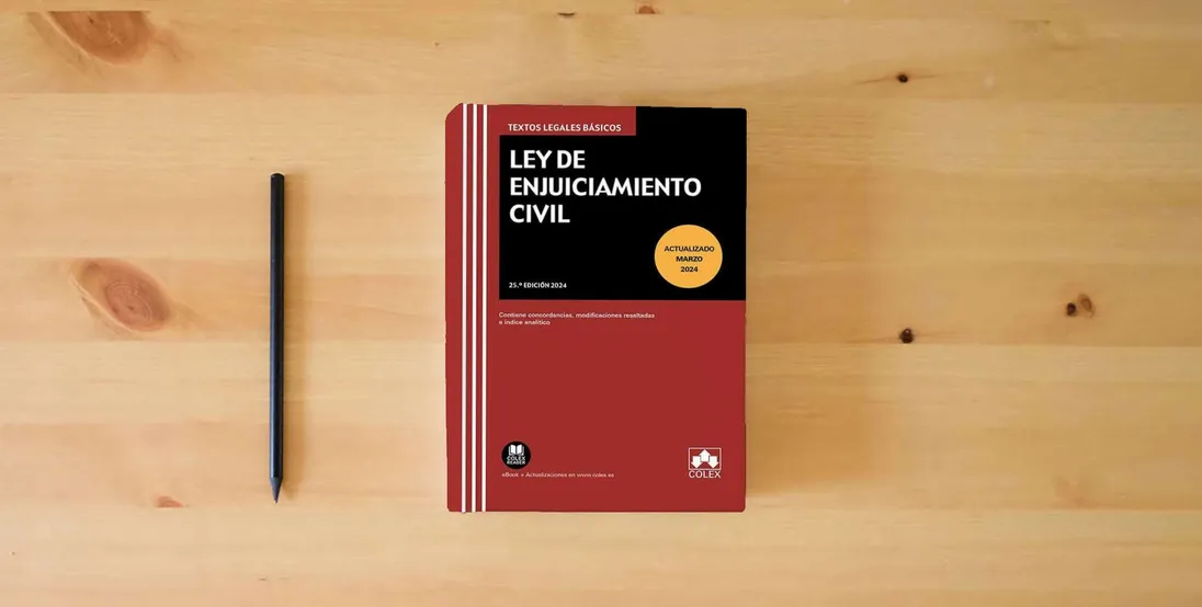 The book Ley de enjuiciamiento civil (25.ª EDICIÓN 2024) (Textos legales básicos)} is on the table