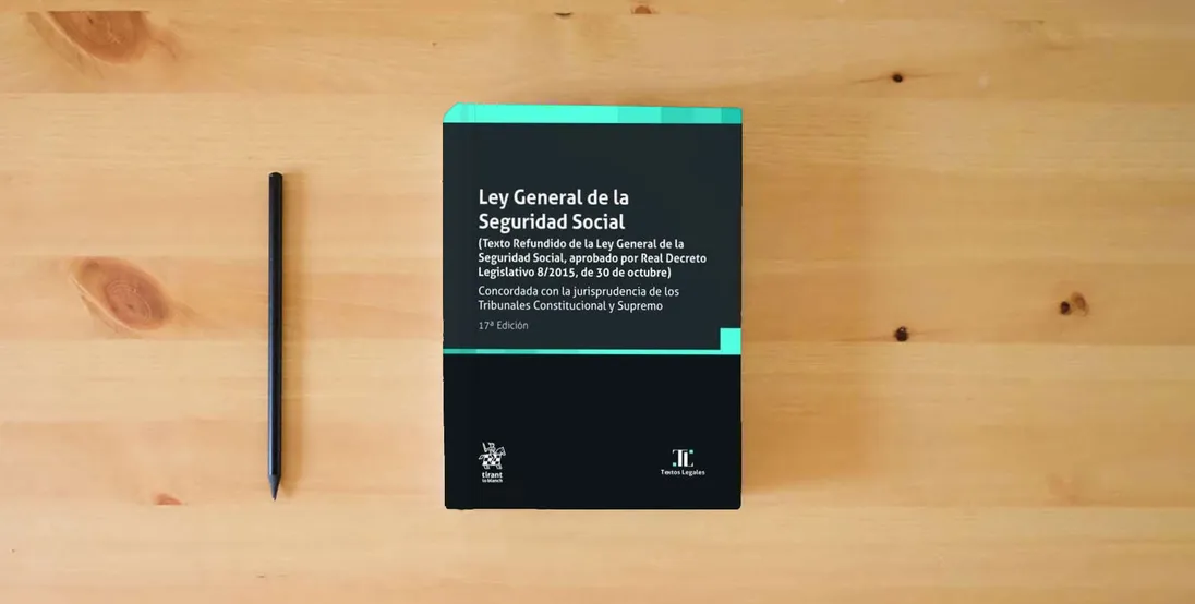 The book Ley General de la Seguridad Social 17ª Edición 2023 (Textos Legales)} is on the table