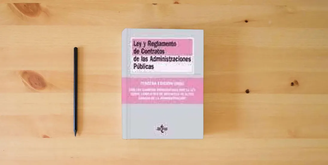 The book Ley y reglamentos de contratos de las administraciones públicas (Derecho)} is on the table