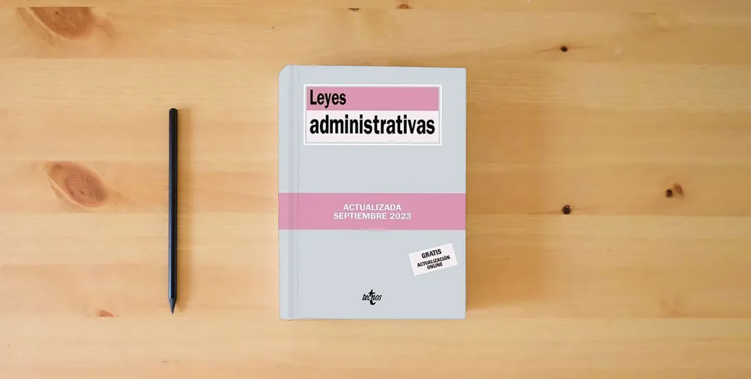 The book Leyes administrativas (Derecho - Biblioteca de Textos Legales)} is on the table
