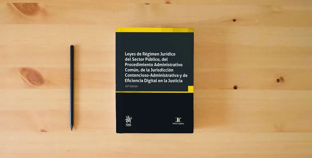The book Leyes de Régimen Jurídico del Sector Público, del Procedimiento Administrativo Común, de la Jurisdicción 10ª Edición (Textos Legales)} is on the table
