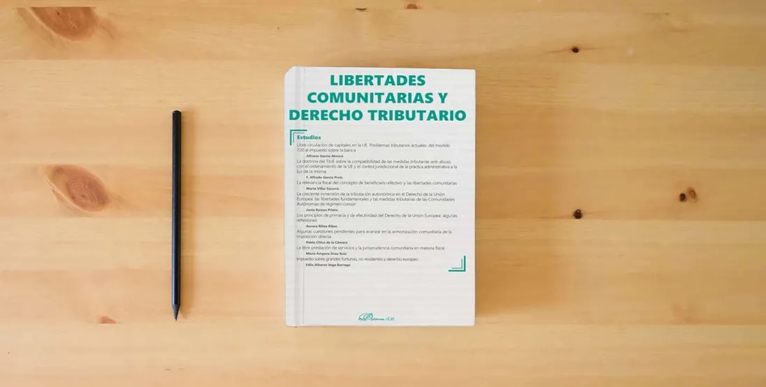 The book Libertades comunitarias y derecho tributario: Monográfico revista Nueva Fiscalidad. 2023 (SIN COLECCION)} is on the table
