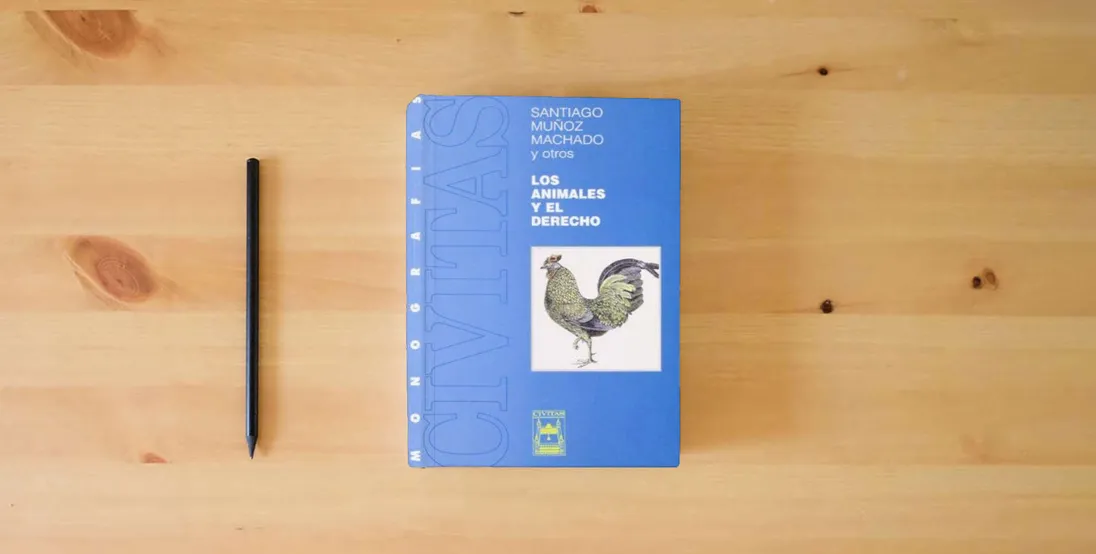 The book Los Animales y El Derecho (Monografía)} is on the table