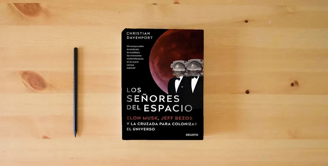 The book Los señores del espacio: Elon Musk, Jeff Bezos y la cruzada para colonizar el universo (Deusto)} is on the table