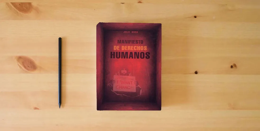 The book Manifiesto de derechos humanos (Documentos)} is on the table