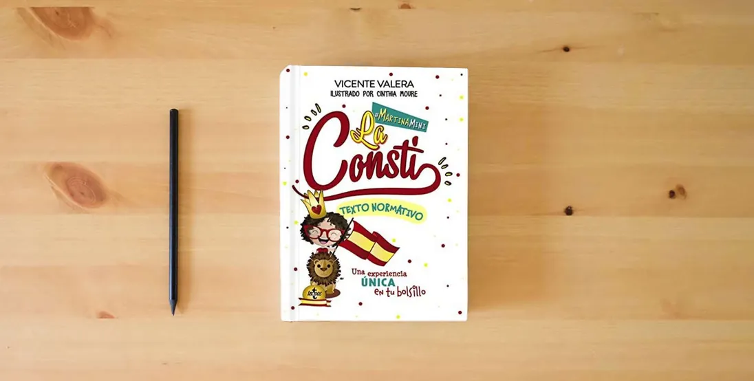 The book Martina mini. La Consti: La Constitución Española. Texto normativo (Derecho - Práctica Jurídica)} is on the table