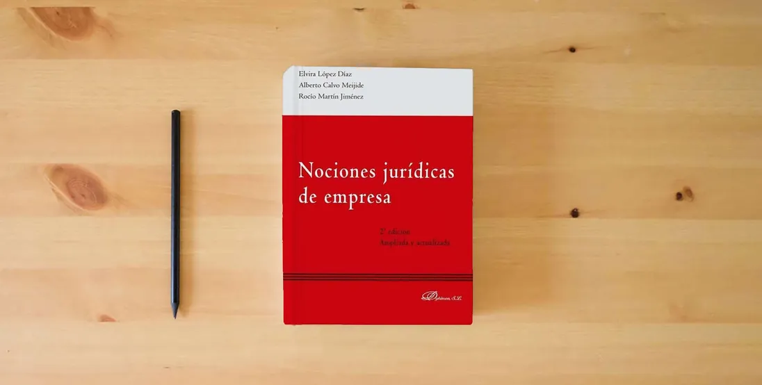 The book Nociones jurídicas de empresa (SIN COLECCION)} is on the table