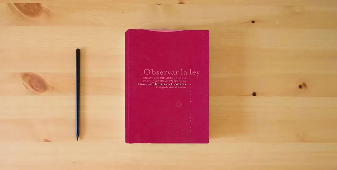 The book Observar La Ley. Ensayos Sobre Metodología De La Investigación Jurídica (ESTRUCTURAS Y PROCESOS - DERECHO)} is on the table