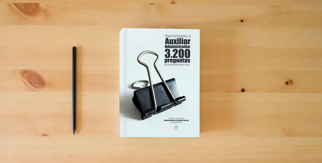 The book Oposiciones a Auxiliar Administrativo 3200 preguntas tipo test: Incluye anexo sobre Ayuntamientos y Entidades locales y acceso online} is on the table