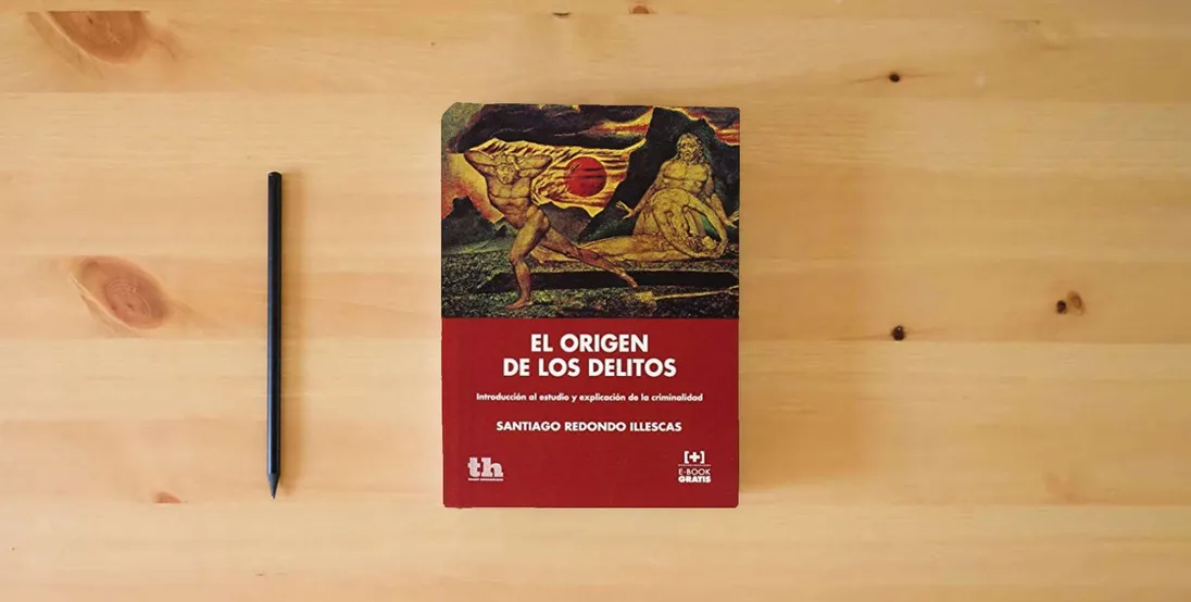 The book El Origen de los Delitos (Plural)} is on the table