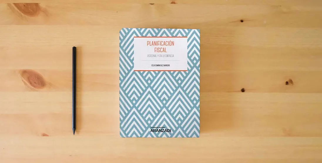 The book Planificación Fiscal: Personal y en la empresa (Manuales)} is on the table