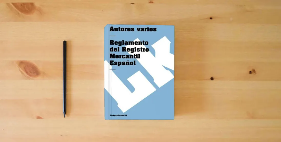 The book Reglamento del Registro Mercantil Español: 54 (Leyes)} is on the table