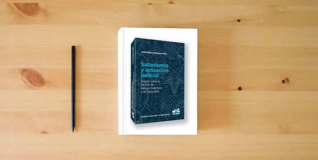 The book Satanismos y actuación policial: Estudio sobre la gestión de riesgos delictivos y de seguridad: 38 (Colección "Penalcrim" J.M. Bosch Editor)} is on the table