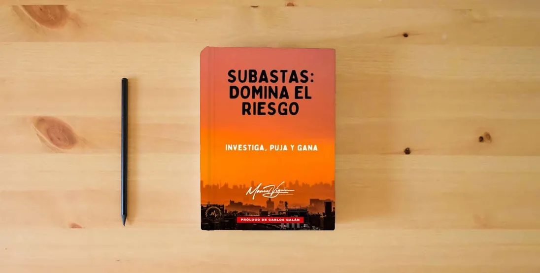 The book SUBASTAS: domina el riesgo: Investiga, puja y gana} is on the table