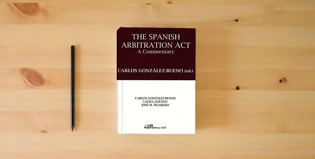 The book The Spanish arbitration act. A commentary (SIN COLECCION)} is on the table