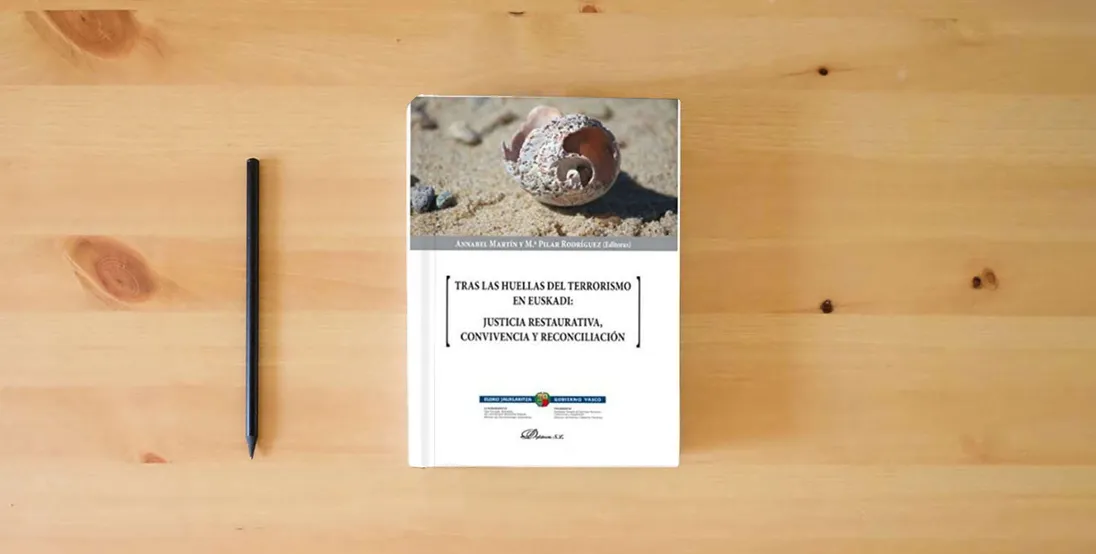 The book Tras Las Huellas Del Terrorismo En Euskadi: Justicia Restaurativa, convivencia y reconciliación (SIN COLECCION)} is on the table